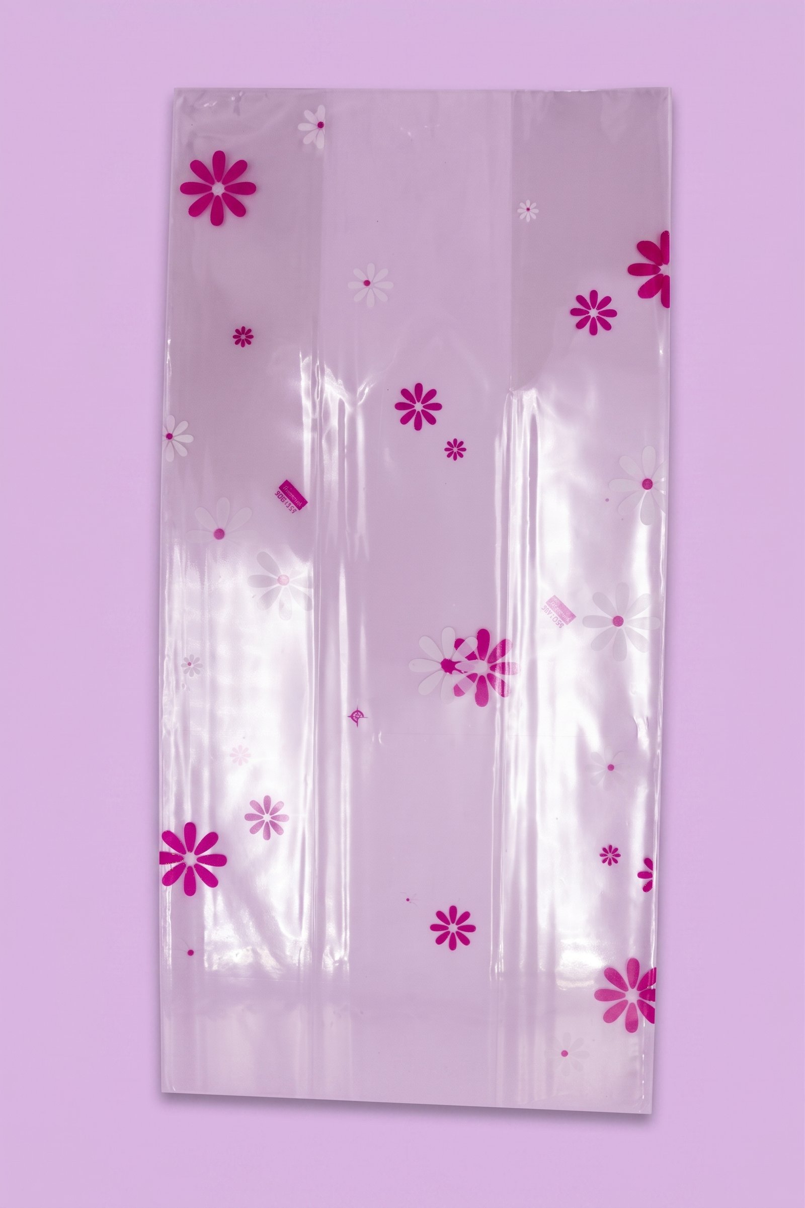 Bolsa de celofán peluchera decorada con flores tipo margaritas color rosa, venta al mayoreo